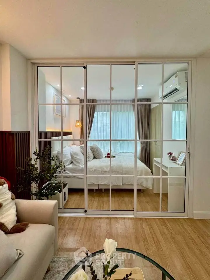 Chic modern bedroom with glass partition and cozy decor