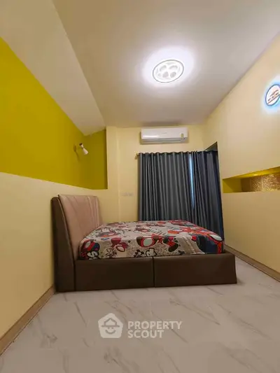 Modern bedroom with stylish bed and vibrant yellow accent wall