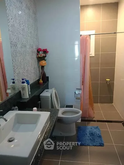 Modern bathroom with stylish tiles and spacious shower area.