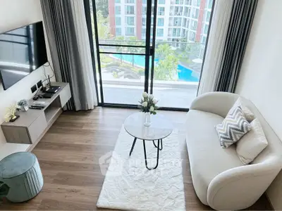 Modern living room with stylish decor and pool view from balcony