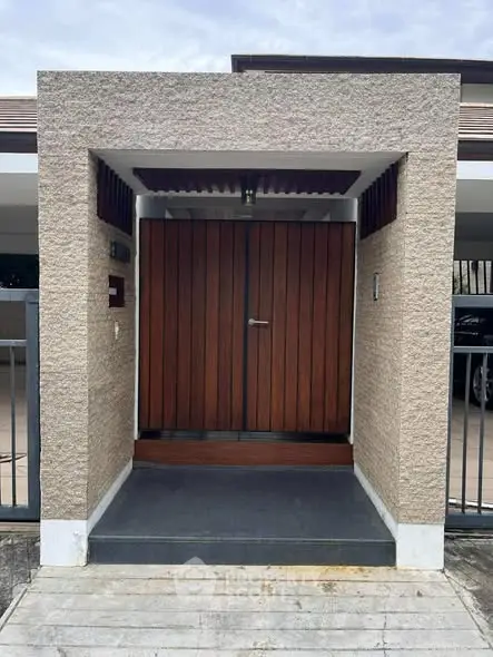 Modern entrance with wooden door and textured walls in contemporary home