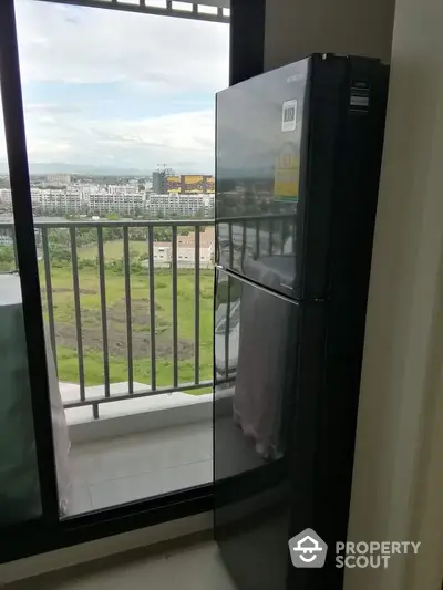 Modern apartment with balcony view and sleek black refrigerator