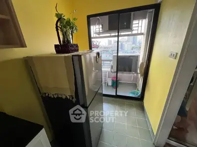 Bright kitchen with yellow walls and balcony view in urban apartment