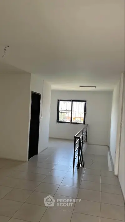 Spacious modern interior with tiled flooring and natural light, ideal for customization.