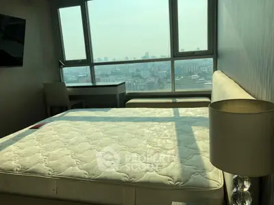 Spacious bedroom with city view and modern furnishings