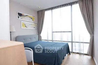 Modern bedroom with large window and stylish decor