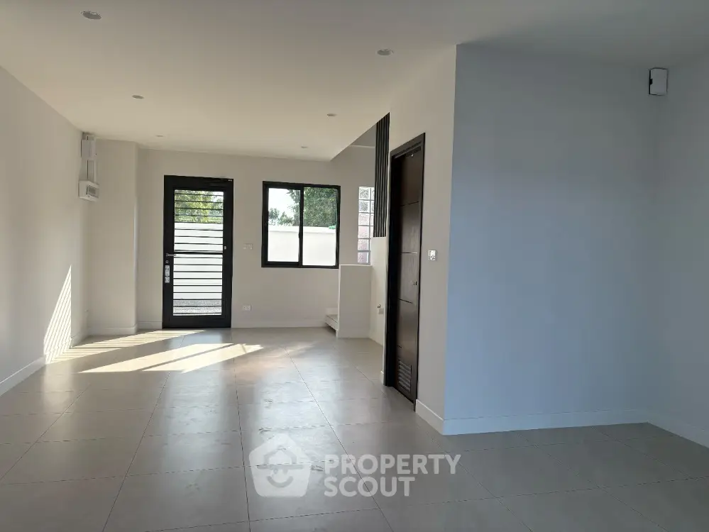 Spacious modern living room with large windows and minimalist design