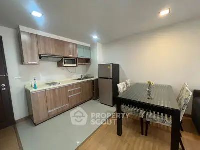 Modern kitchen and dining area with wooden cabinets and sleek appliances