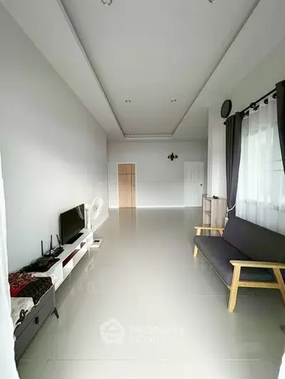 Spacious minimalist living room with sleek furniture and natural light