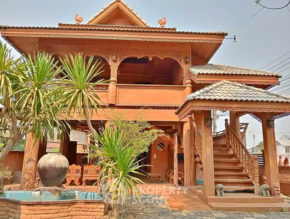 Stunning traditional wooden house with intricate carvings and lush garden