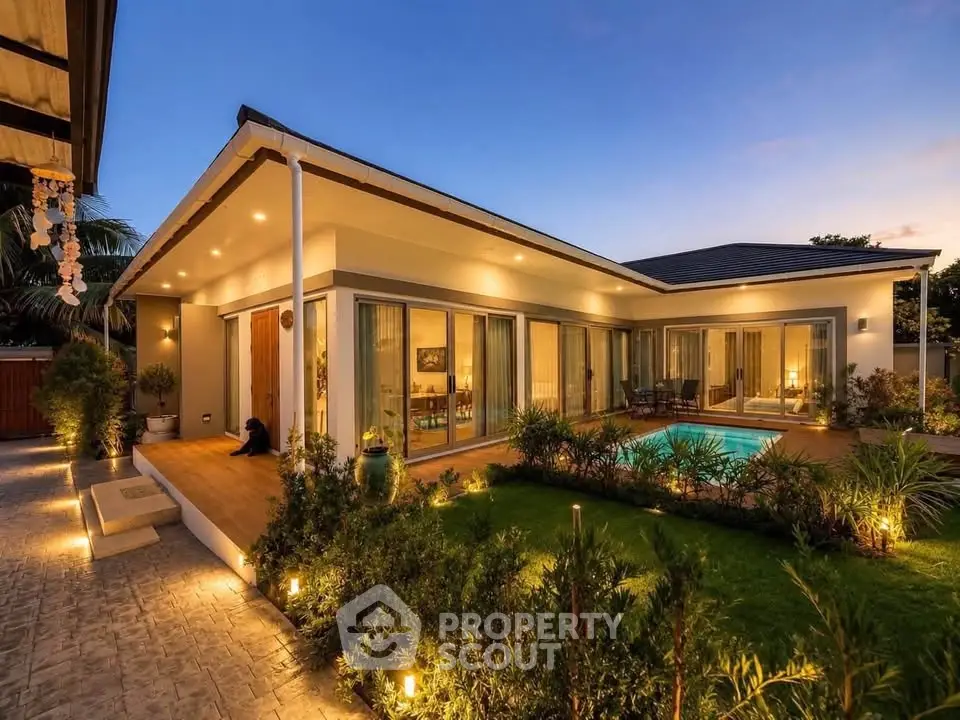 Luxurious modern home with stunning evening lighting and private pool, perfect for serene living.