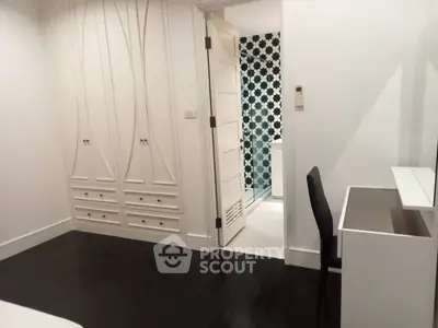 Modern bedroom with elegant closet and view into stylish bathroom