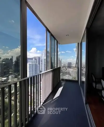 Stunning city view from a modern high-rise balcony with glass railings.