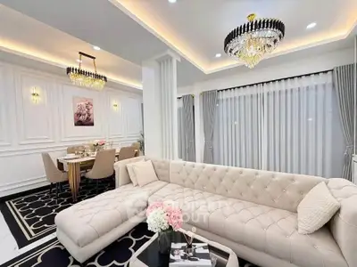 Luxurious living room with elegant chandelier and plush sectional sofa in modern home