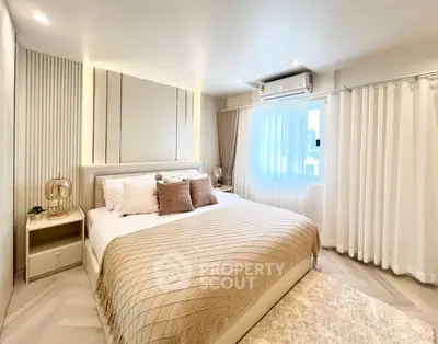 Luxurious bedroom with elegant decor and ample natural light