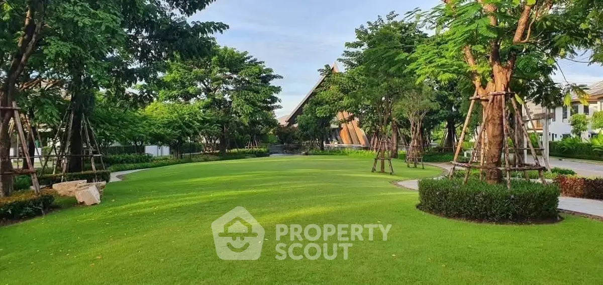 Lush green garden with manicured lawns and mature trees in a serene residential area.