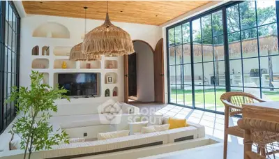 Luxurious living room with large windows, modern decor, and garden view, perfect for relaxation and entertainment.