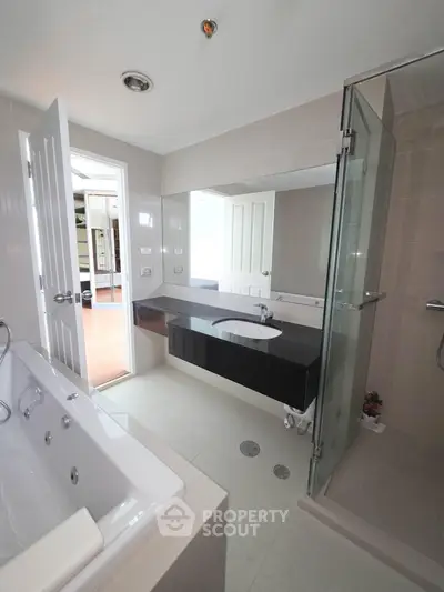 Modern bathroom with glass shower and sleek black vanity