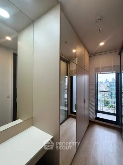 Modern apartment with built-in storage and city view from balcony