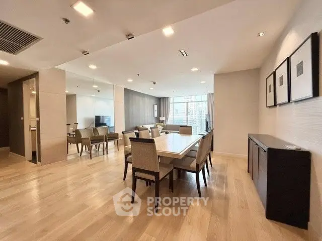 Spacious modern dining and living area with elegant furnishings and natural light.