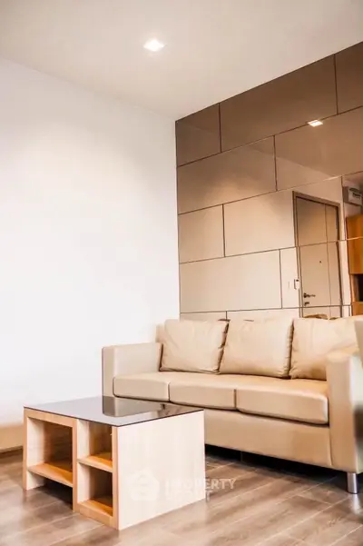 Modern living room with beige sofa and stylish mirrored wall panels