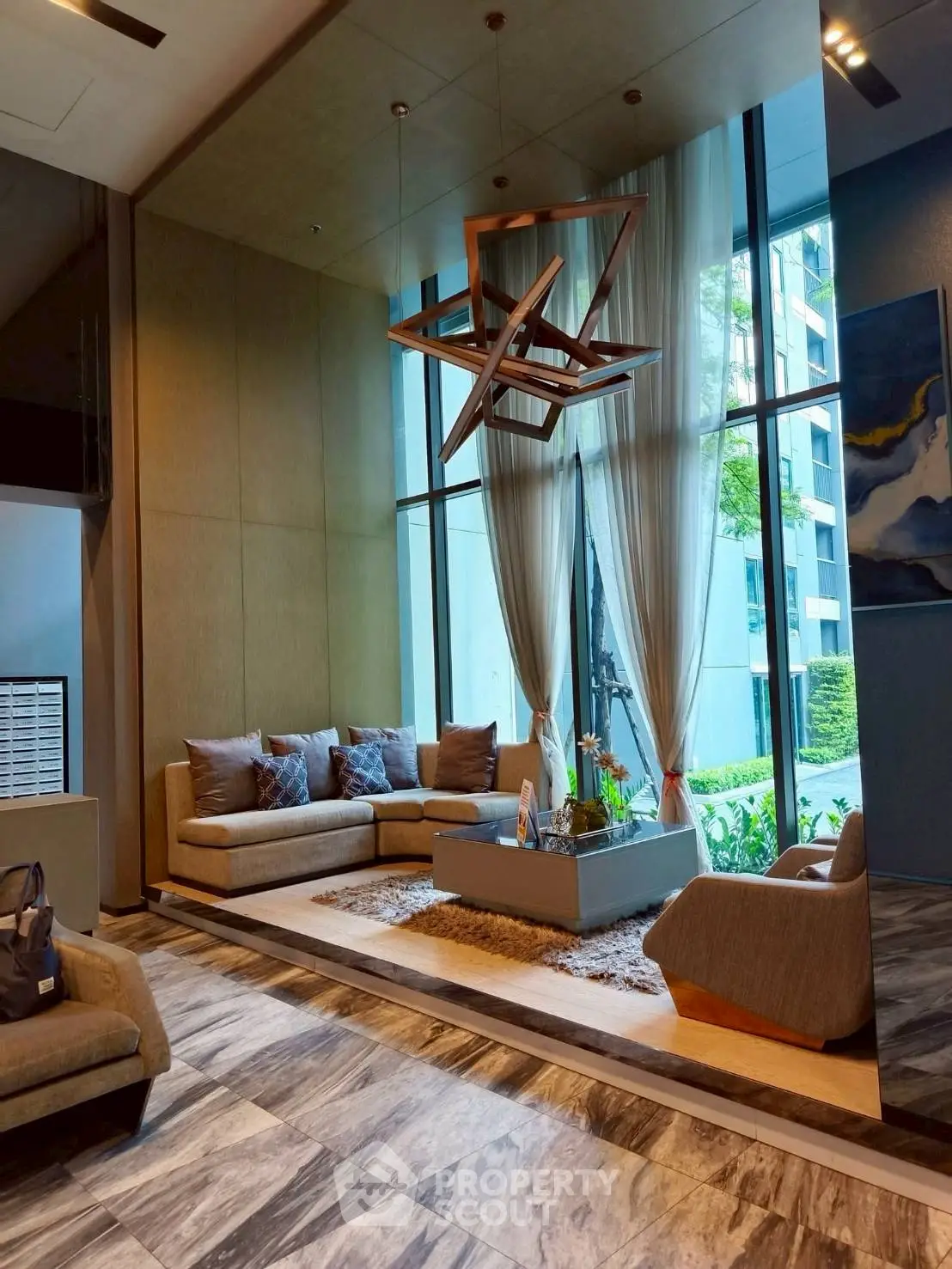 Luxurious modern lobby with elegant seating and large windows in upscale building.