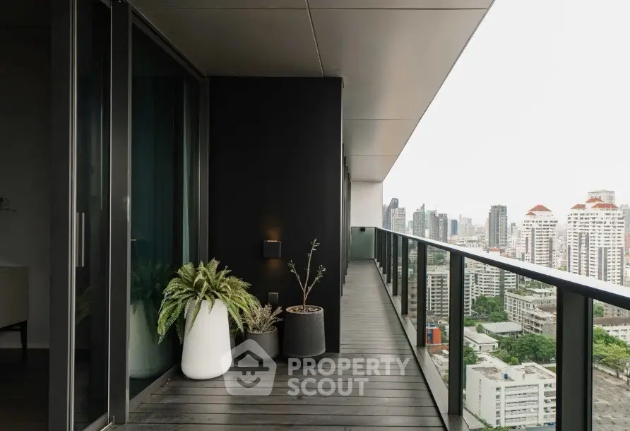 Modern high-rise balcony with stunning cityscape view and sleek design.