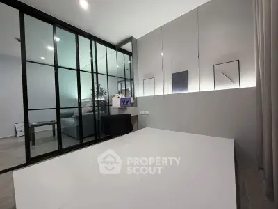 Modern minimalist living room with glass partition and sleek decor