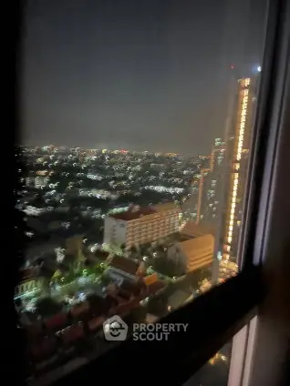 Stunning night cityscape view from high-rise apartment window.