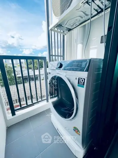 Modern balcony with washing machine and scenic view, perfect for urban living convenience.