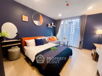 Modern bedroom with stylish decor and large window offering city view