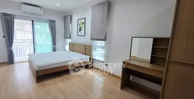 Spacious bedroom with modern furnishings and natural light