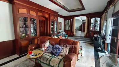 Luxurious living room with elegant wooden cabinetry and plush leather seating