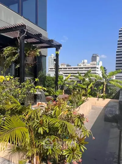 Luxurious urban balcony with lush greenery and stunning city views.