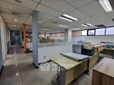 Spacious open-plan office with modern furnishings and ample natural light, ideal for collaborative workspaces.