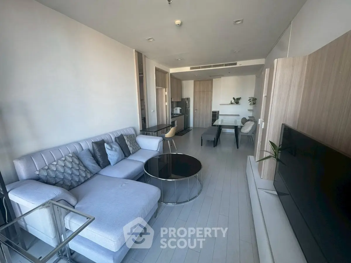 Modern living room with sleek furniture and open layout in a stylish apartment.