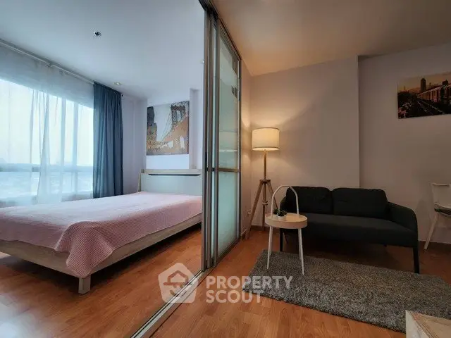 Modern studio apartment with cozy bedroom and living area, featuring wooden flooring and stylish decor.