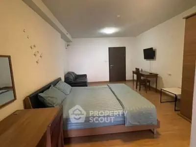 Spacious bedroom with modern furnishings and cozy ambiance, perfect for relaxation and comfort.