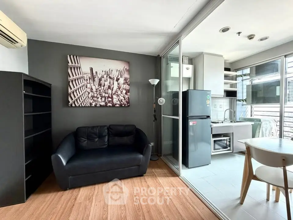 Modern living room with sleek kitchen and stylish decor