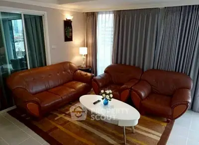 Elegant living room with leather sofas and modern decor, perfect for relaxation and entertaining.