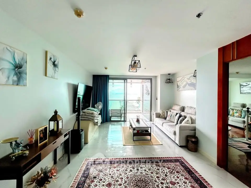 Spacious living room with modern decor and large balcony offering stunning views.