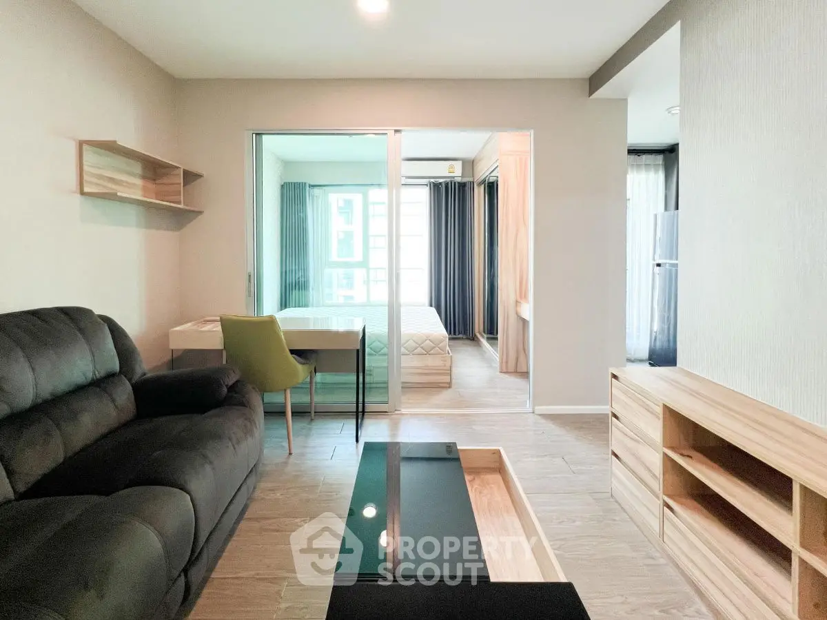 Modern living room with sleek furniture and natural light in stylish apartment.