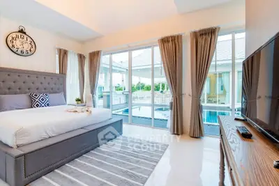 Luxurious bedroom with pool view and elegant decor in modern home