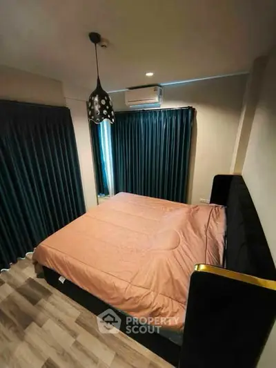 Cozy bedroom with modern decor and stylish lighting in a contemporary apartment.