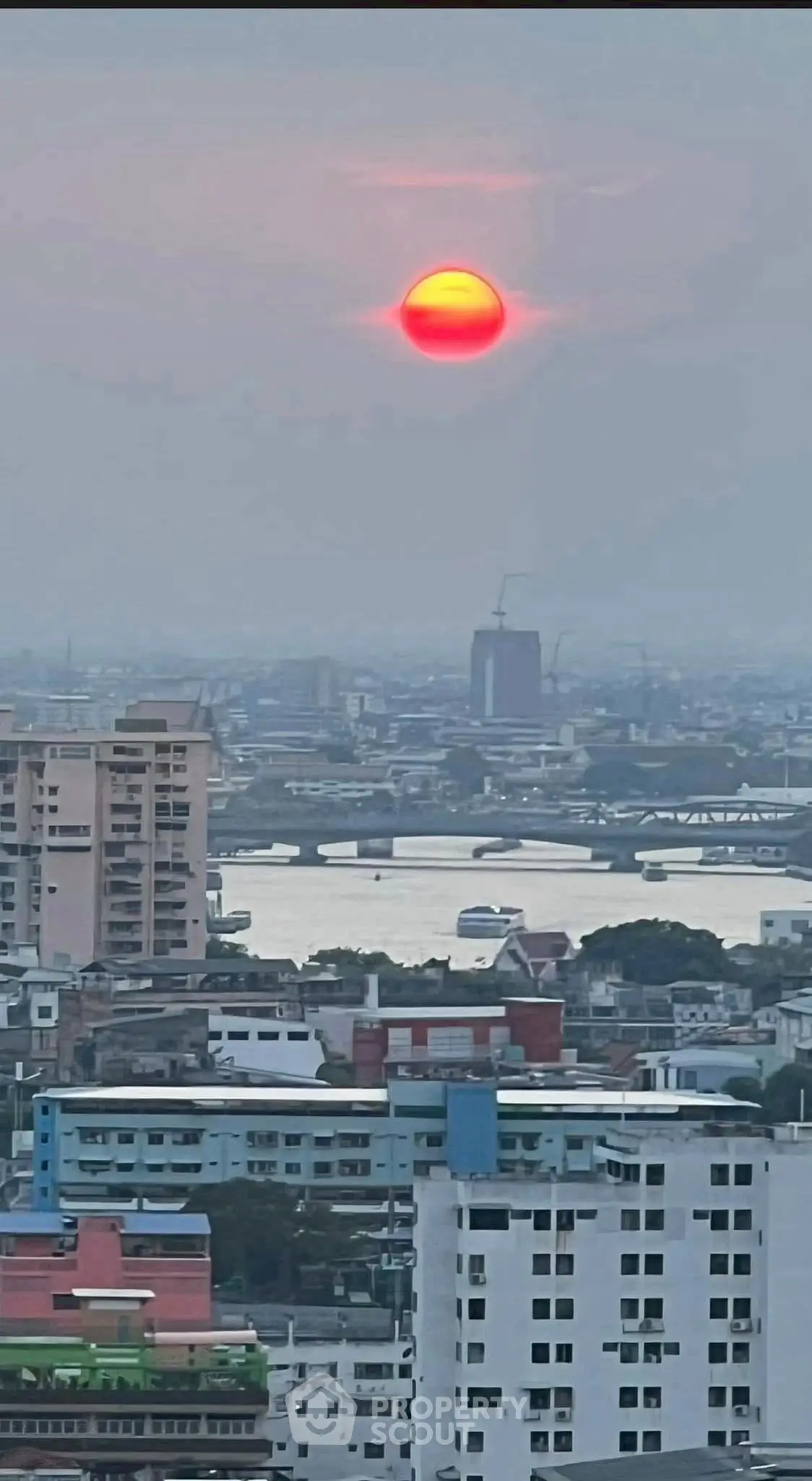Stunning cityscape view with a vibrant sunset over urban skyline, perfect for high-rise living enthusiasts.