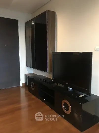 Modern living room with sleek black entertainment center and flat-screen TV
