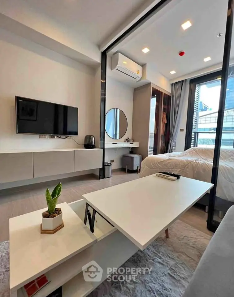 Modern studio apartment with sleek design, featuring a cozy living area and stylish bedroom.