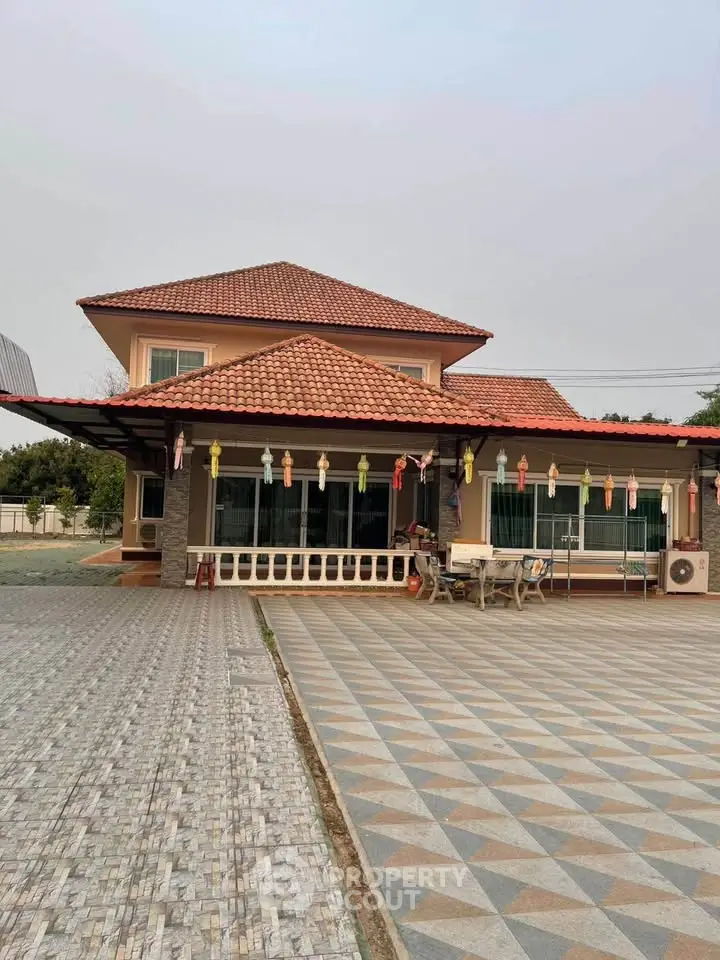 Charming two-story house with tiled roof and spacious driveway, perfect for family living.