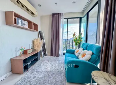 Bright living room with modern decor and stunning balcony view