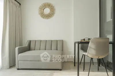 Modern living room with stylish sofa and dining area, perfect for cozy urban living.